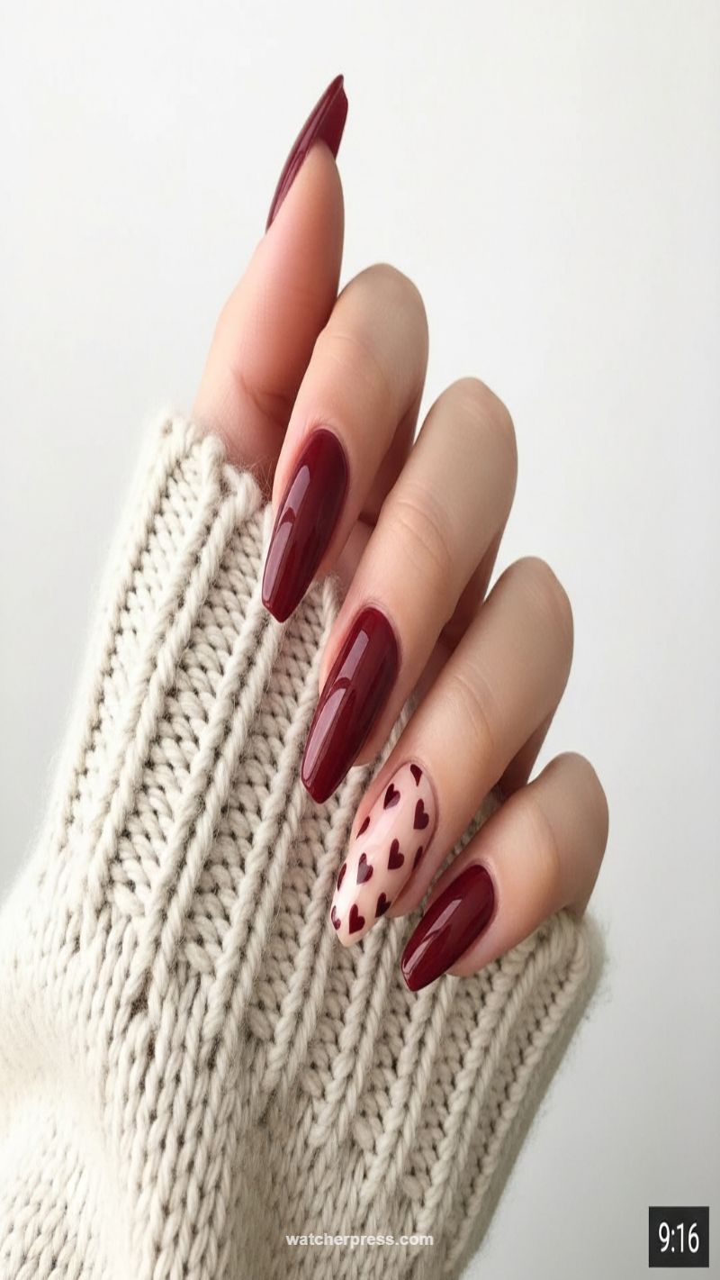 5. Burgundy Almond Nails with Dainty Heart Overlays